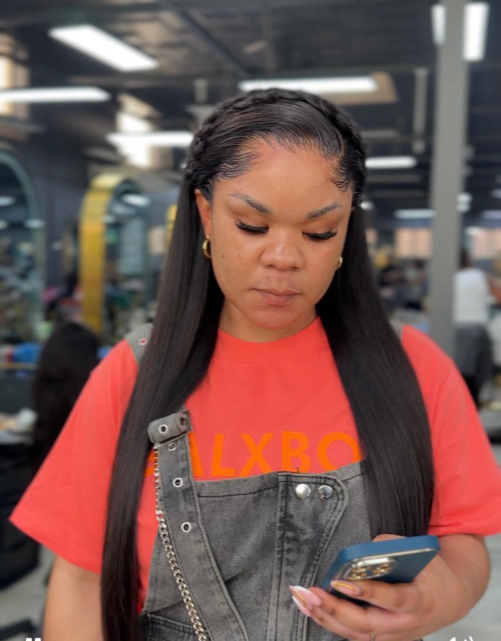 Client wearing a long straight installation with a braided crown detail