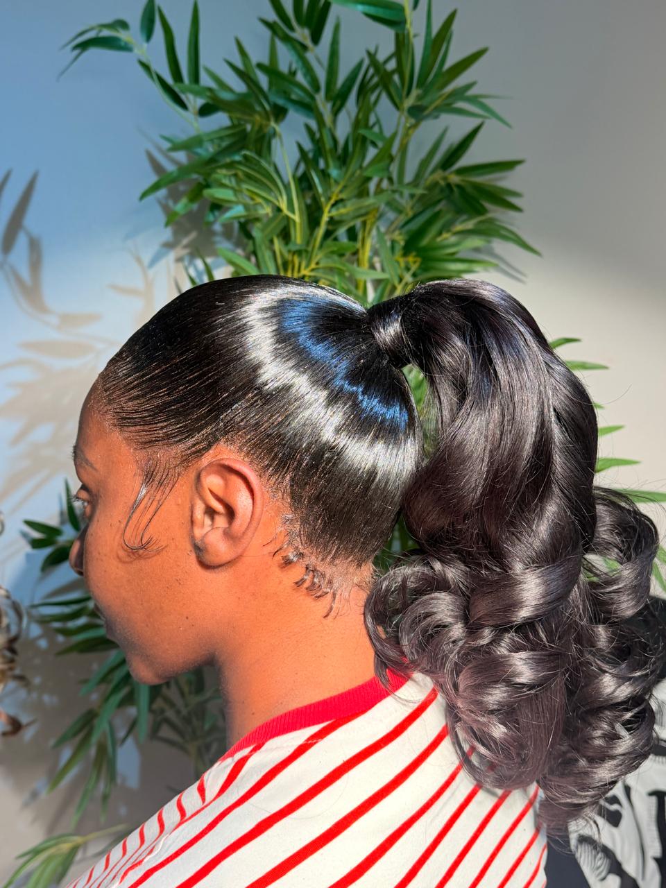 Side view of a glossy curled two-frontal ponytail on transparent lace