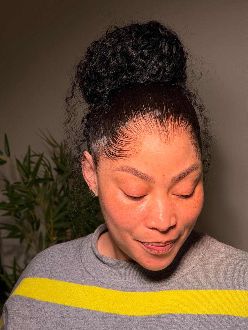 Front view of a curly frontal ponytail with a carefully styled hairline