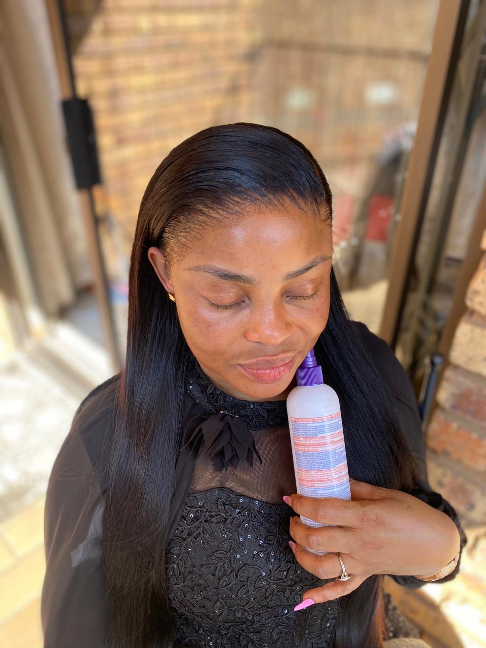 Client wearing a long straight glueless wig with a side part